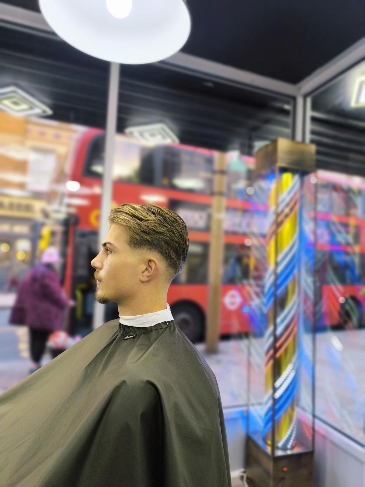 Barber using clippers on a skin fade