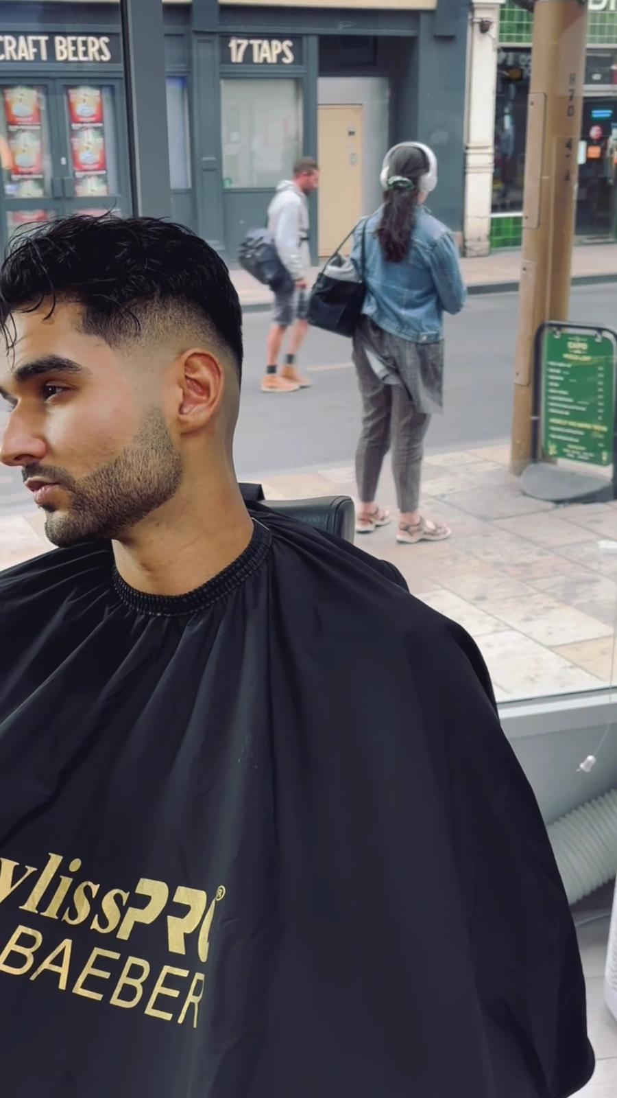 A barber and a client in the shop